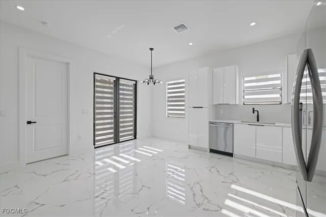 a view of kitchen with granite countertop a sink and a stove top oven