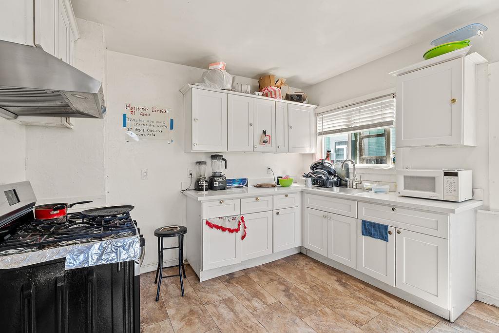 1205 Grand Avenue Santa Rosa, CA 95404 - Photo 22 of 27 a kitchen with white cabinets and white appliances