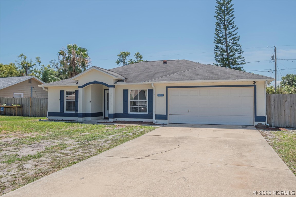 a front view of a house with a garden and yard