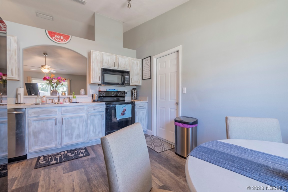2716 Juniper Drive Edgewater, FL 32141 - Photo 12 of 30 a kitchen with stainless steel appliances a refrigerator and a stove top oven