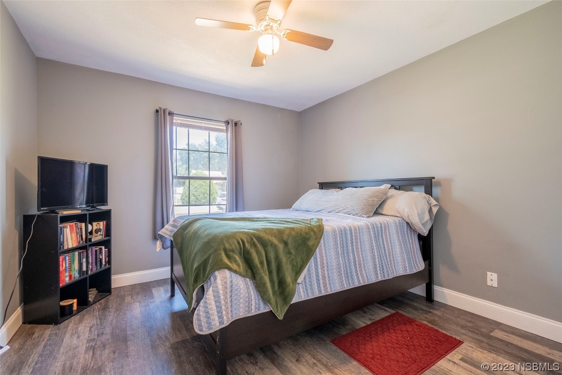 2716 Juniper Drive Edgewater, FL 32141 - Photo 21 of 30 a bedroom with a bed and a flat screen tv