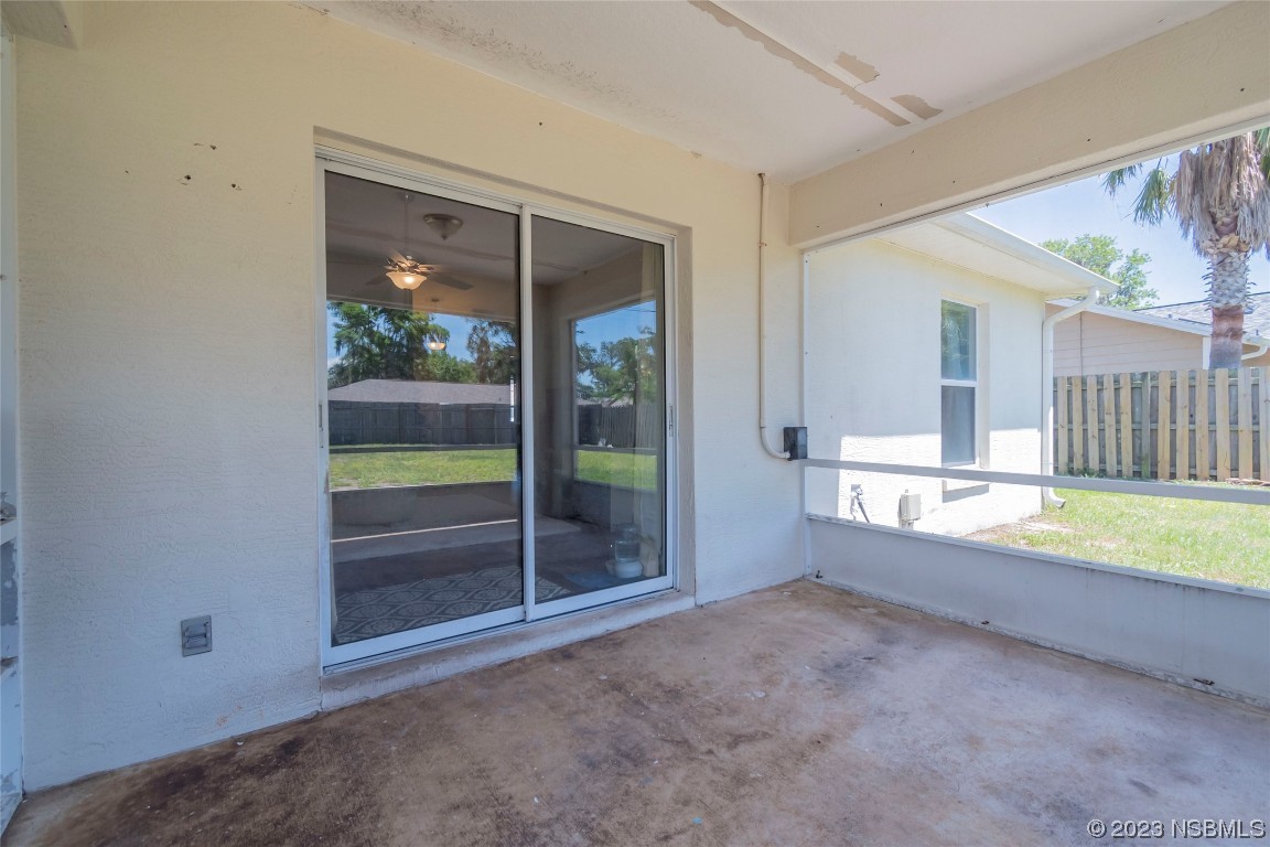 2716 Juniper Drive Edgewater, FL 32141 - Photo 28 of 30 an empty room with floor to ceiling windows and yard