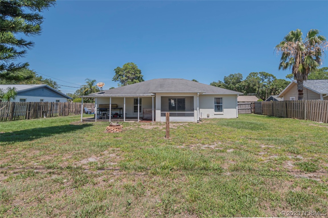 2716 Juniper Drive Edgewater, FL 32141 - Photo 4 of 30 a front view of a house with a garden