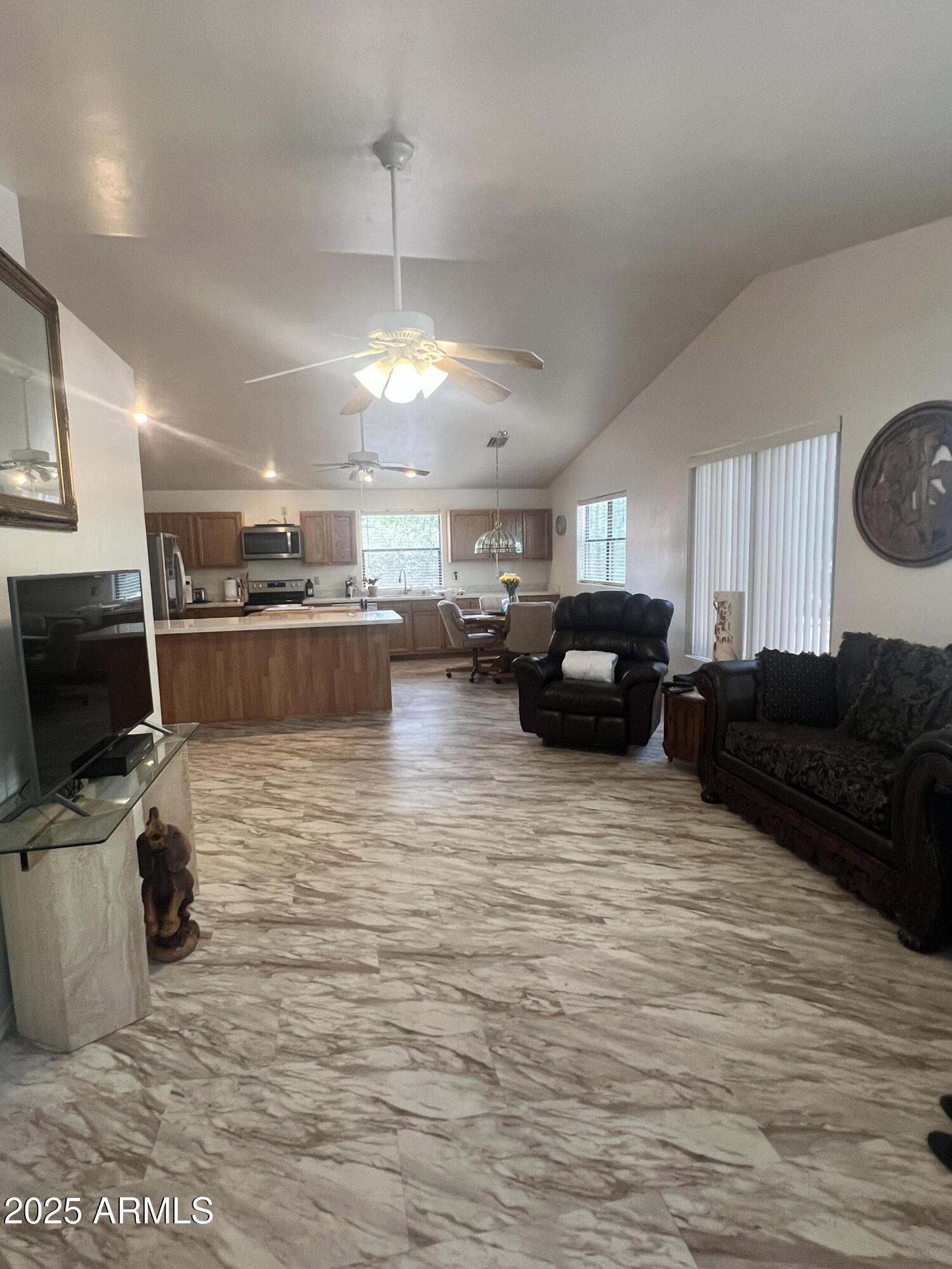 401 East Alpine Drive Payson, AZ 85541 - Photo 11 of 30 a living room with furniture a flat screen tv and kitchen view