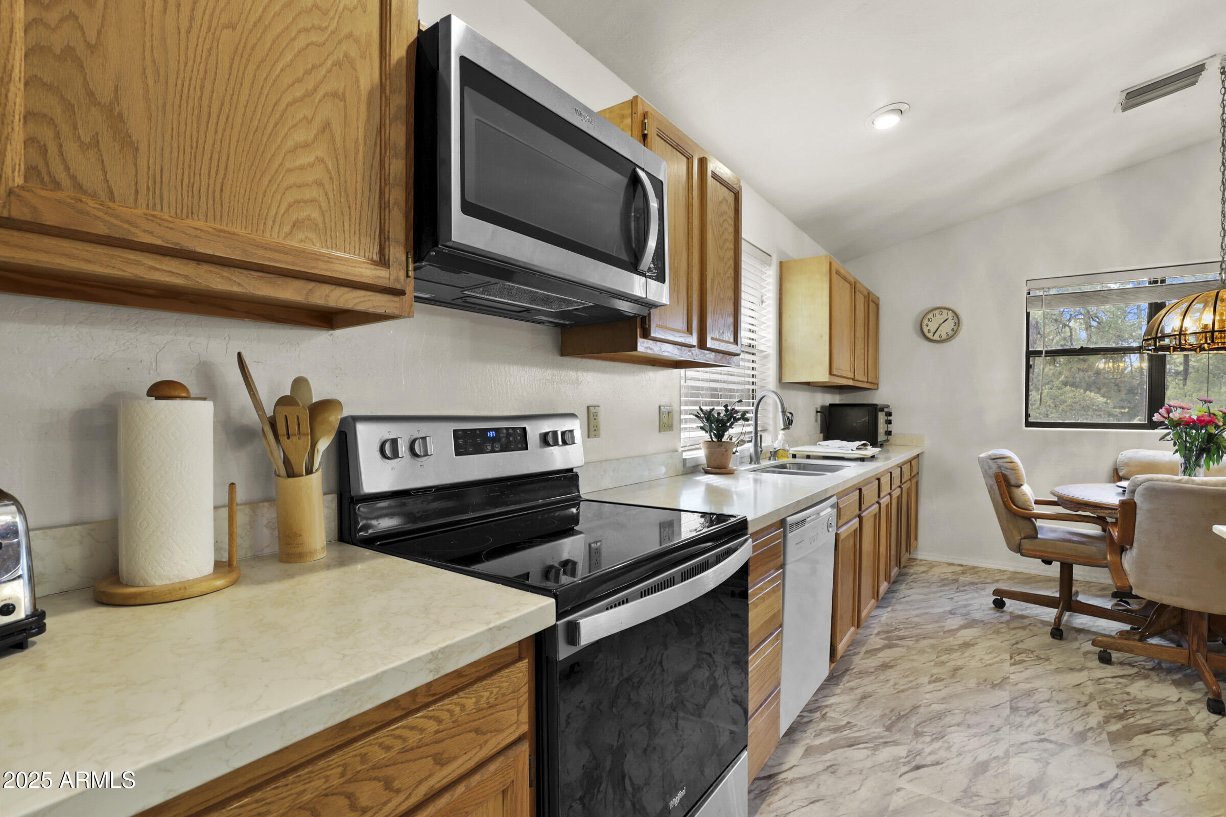401 East Alpine Drive Payson, AZ 85541 - Photo 15 of 30 a kitchen with stainless steel appliances granite countertop a stove top oven a sink dishwasher and white cabinets