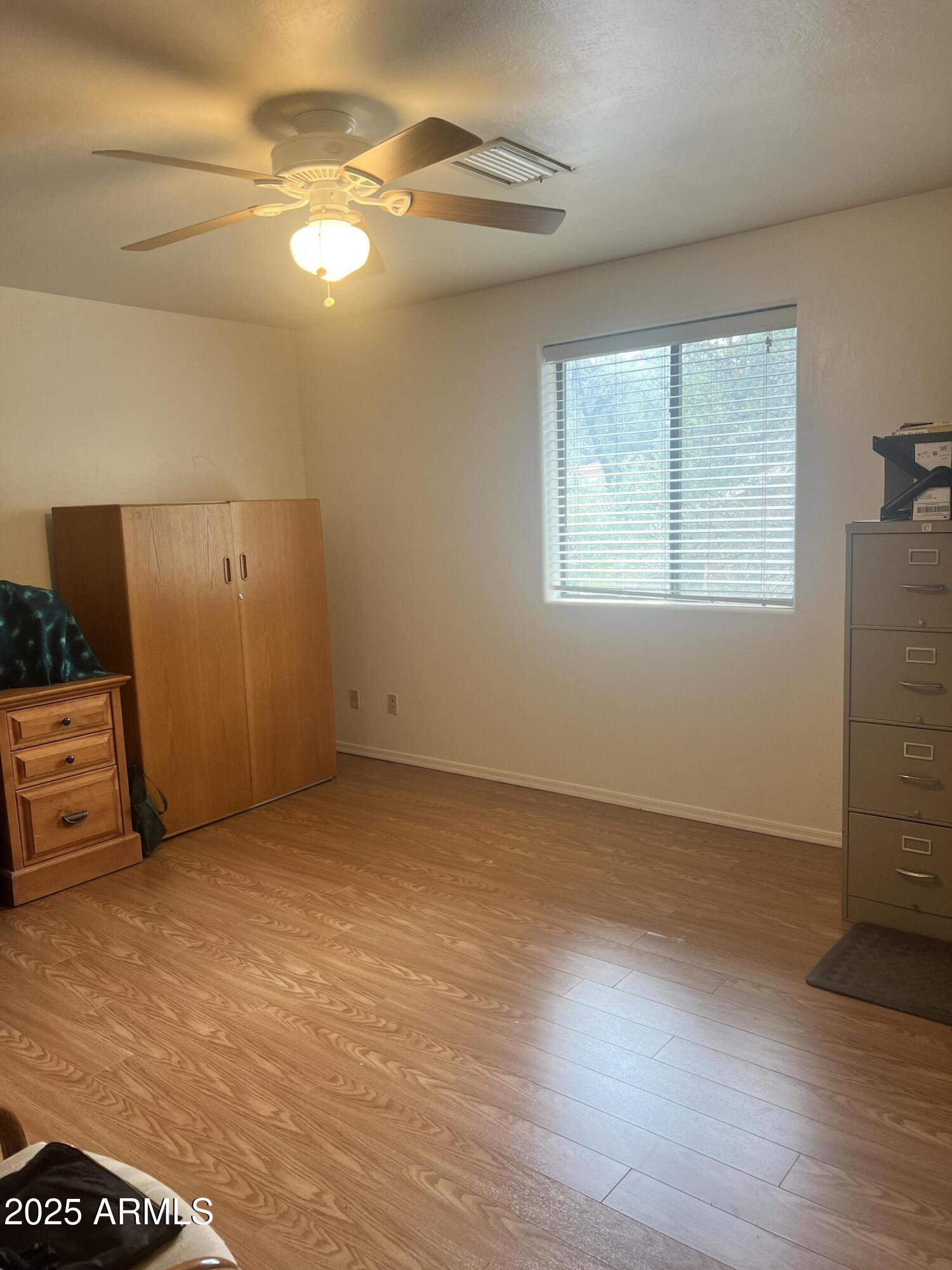401 East Alpine Drive Payson, AZ 85541 - Photo 24 of 30 an empty room with wooden floor and windows
