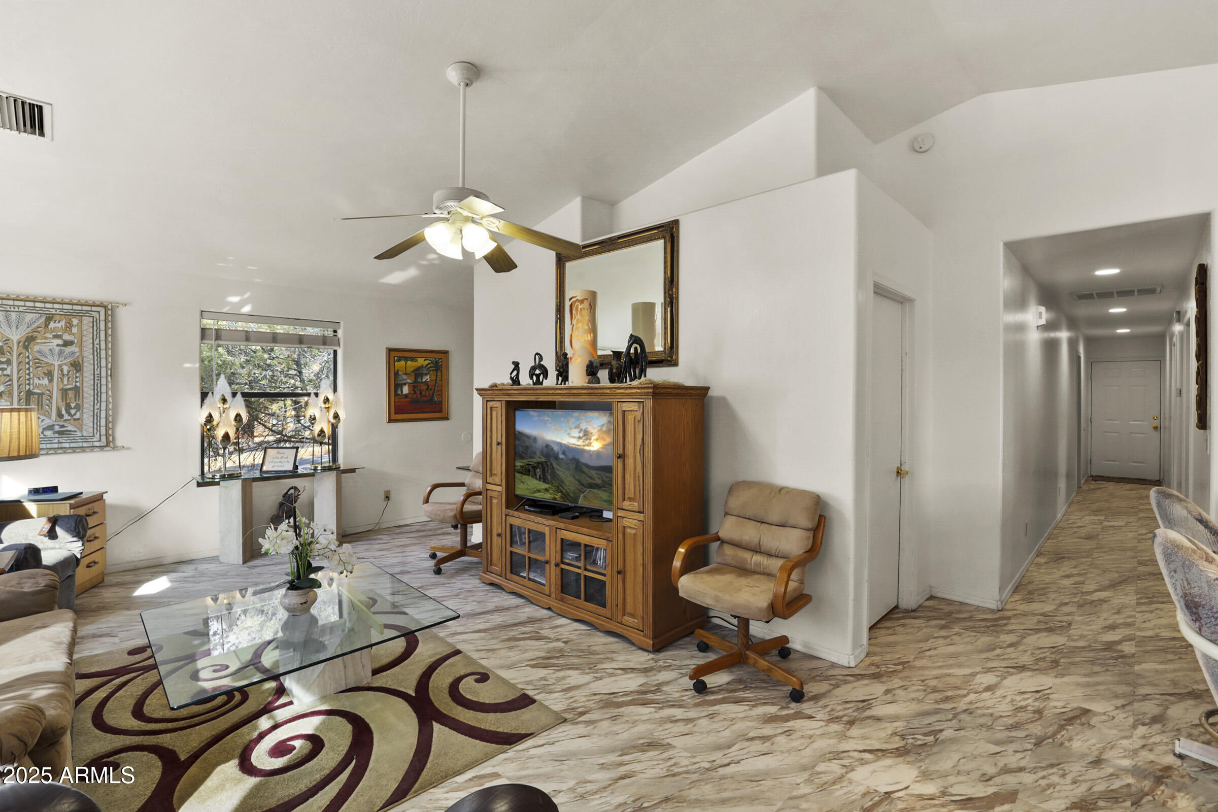 401 East Alpine Drive Payson, AZ 85541 - Photo 9 of 30 a living room with furniture a flat screen tv and a window