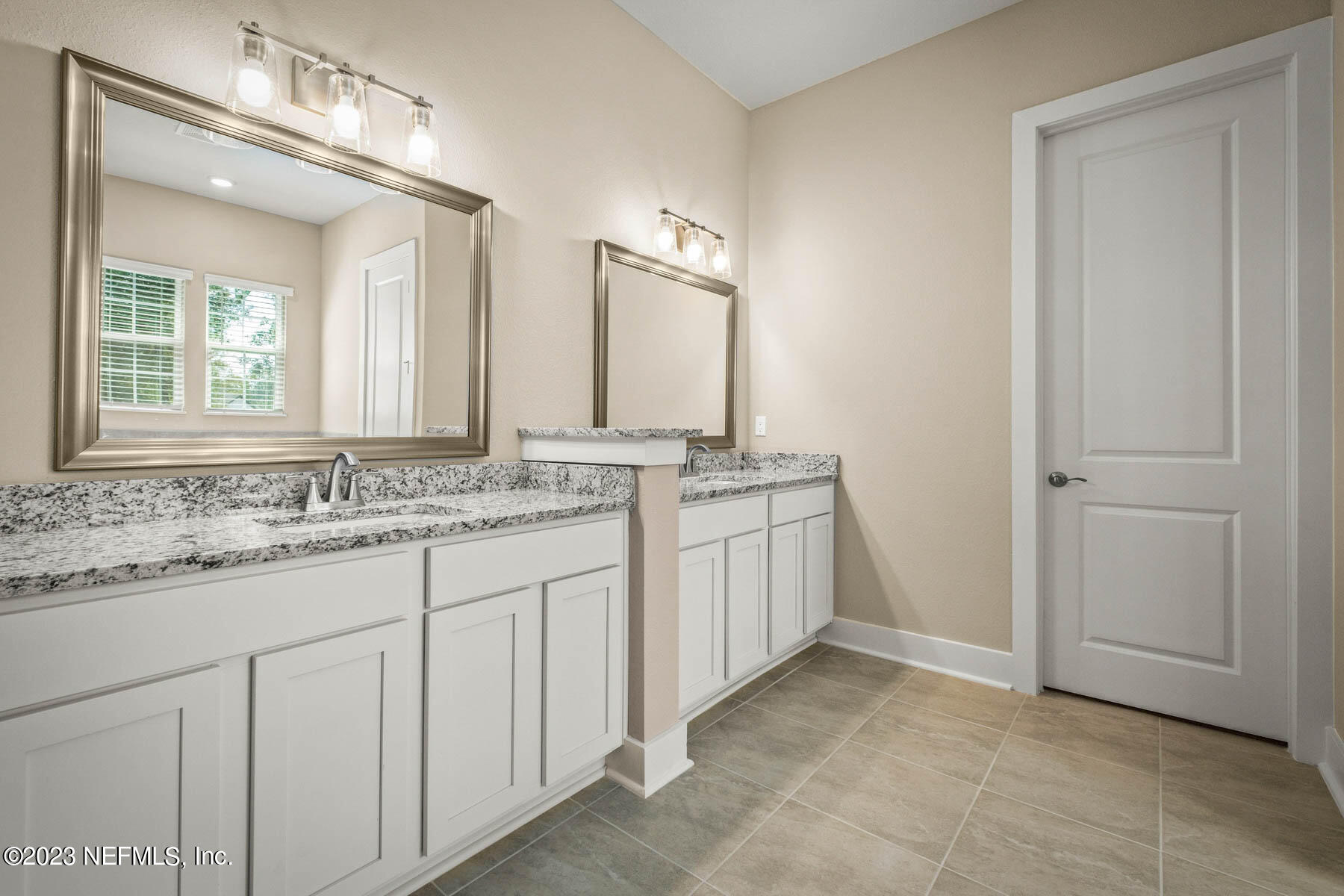 36426 Pitch Lane Hilliard, FL 32046 - Photo 11 of 14 a bathroom with a double vanity sink and a mirror