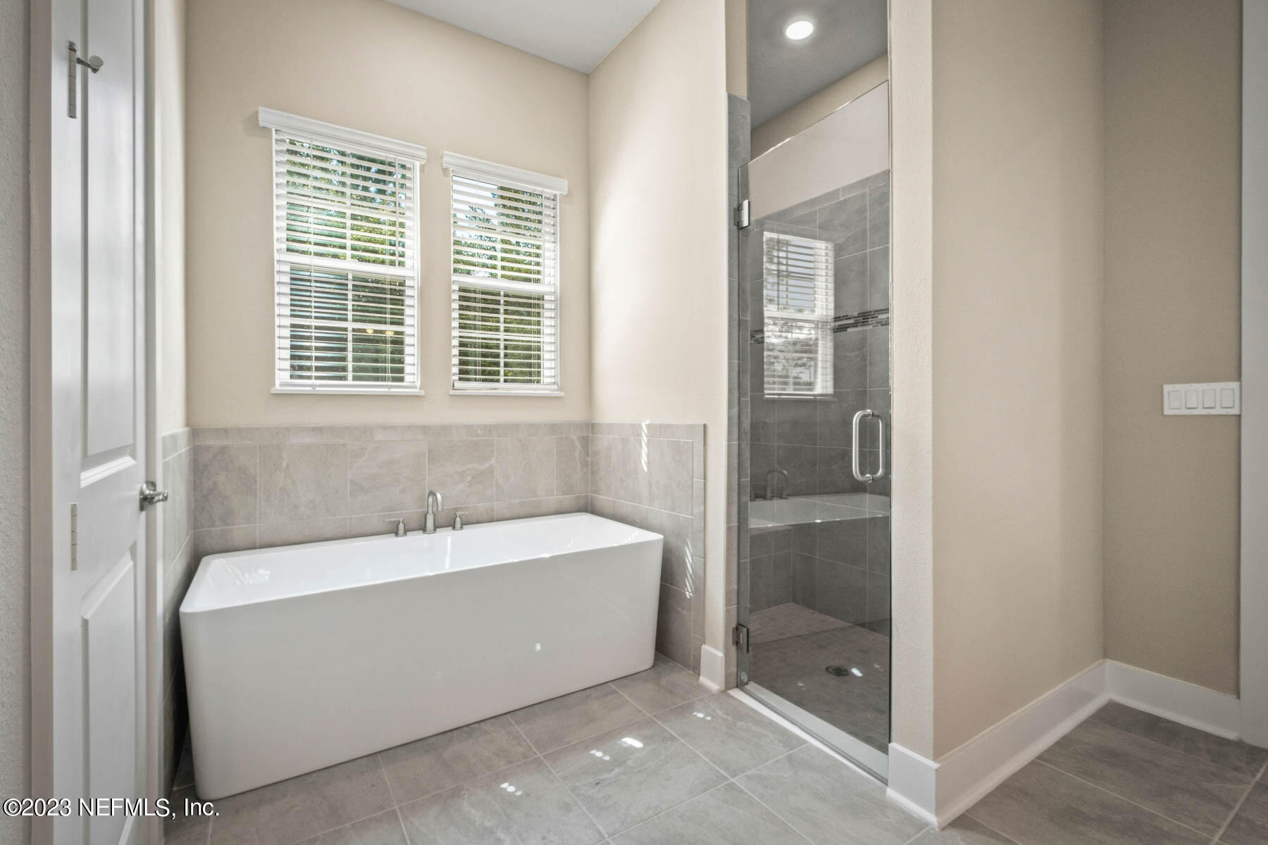 36426 Pitch Lane Hilliard, FL 32046 - Photo 12 of 14 a bathroom with a bathtub and a shower