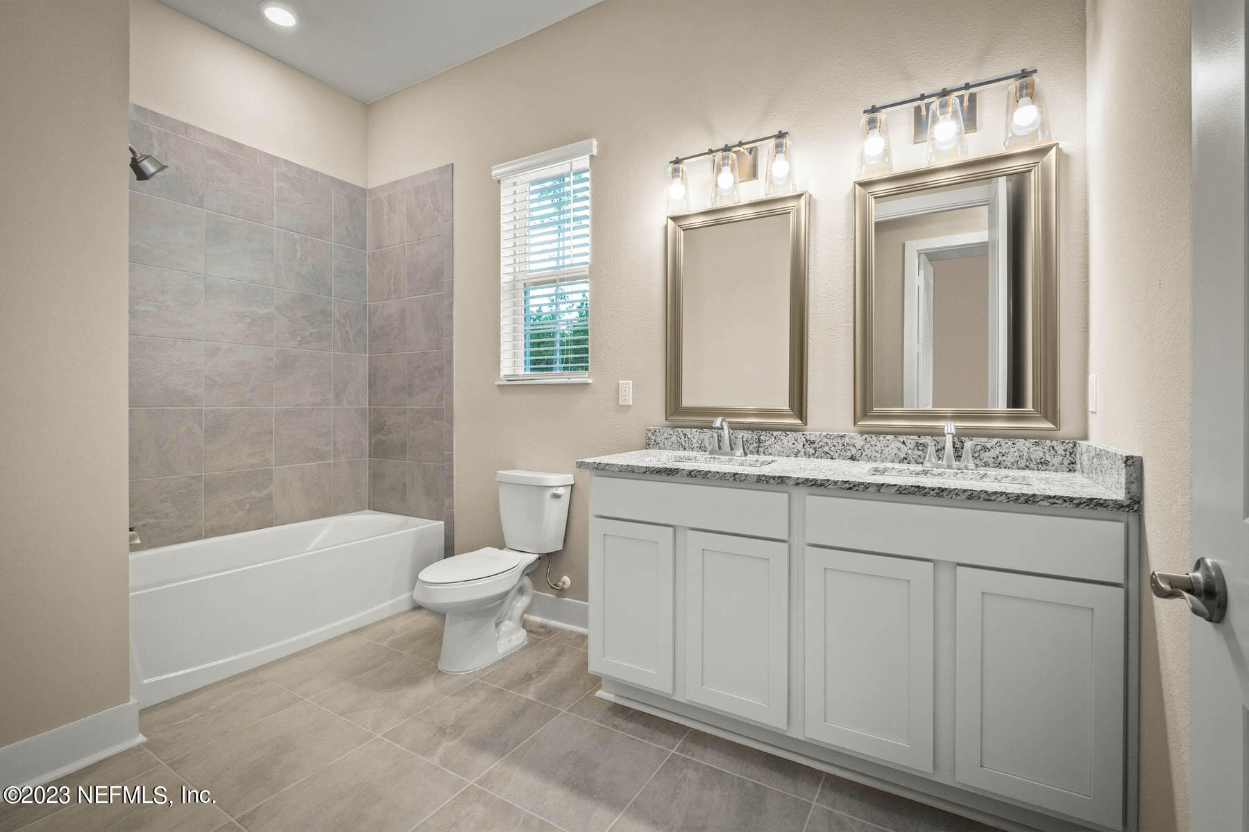 36426 Pitch Lane Hilliard, FL 32046 - Photo 14 of 14 a bathroom with a granite countertop sink toilet and shower