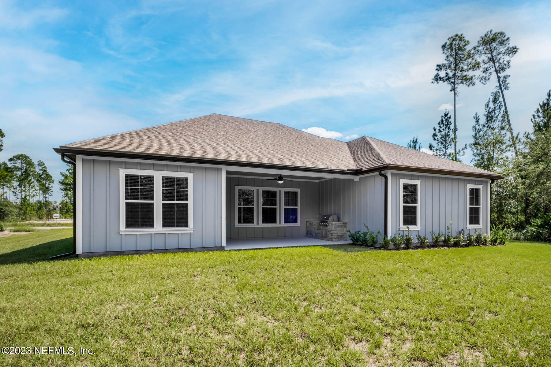 36426 Pitch Lane Hilliard, FL 32046 - Photo 2 of 14 a front view of house with yard and trees in the background