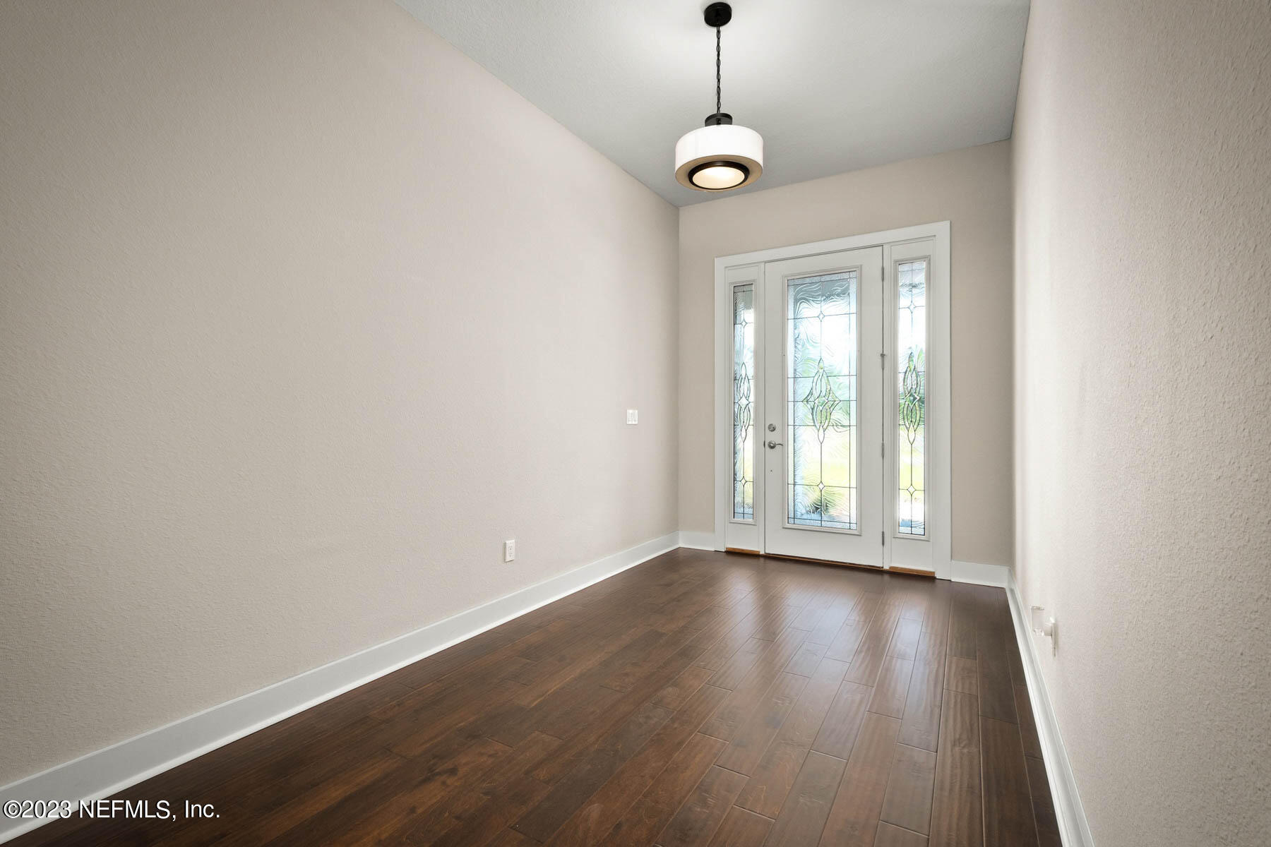 36426 Pitch Lane Hilliard, FL 32046 - Photo 3 of 14 a view of an empty room with wooden floor and a window