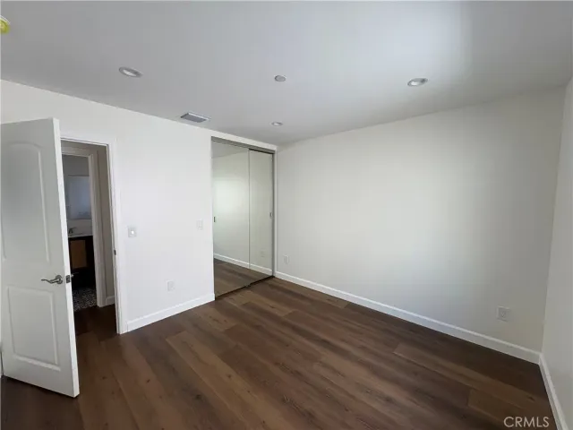 a view of a kitchen with wooden floor and electronic appliances