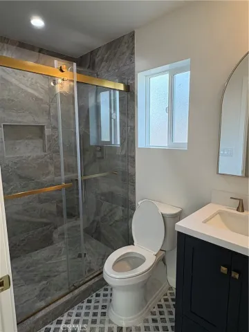 a bathroom with a shower and a toilet
