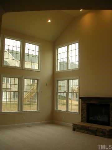 11726 Broadfield Court Raleigh, NC 27617 - Photo 4 of 6 a living room with a fireplace