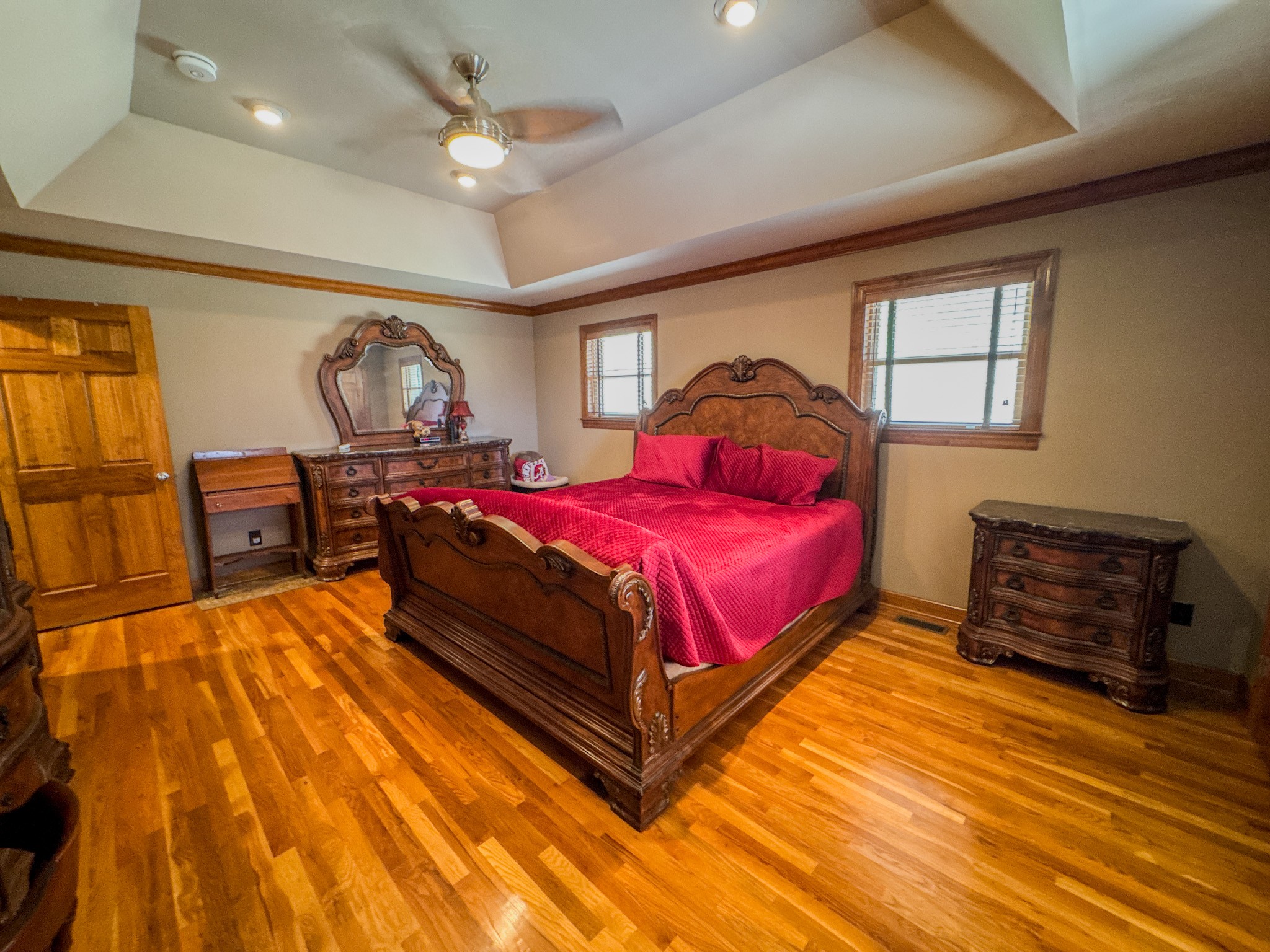 410 Britton Hollow Road Pulaski, TN 38478 - Photo 16 of 59 a spacious bedroom with a bed and a dresser with wooden floor