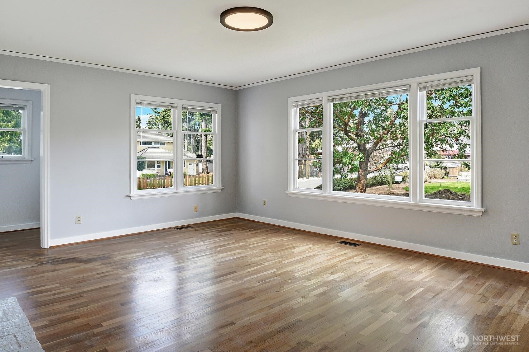 19330 20th Avenue Northwest Shoreline, WA 98177 - Photo 3 of 18 a view of an empty room with wooden floor and a window