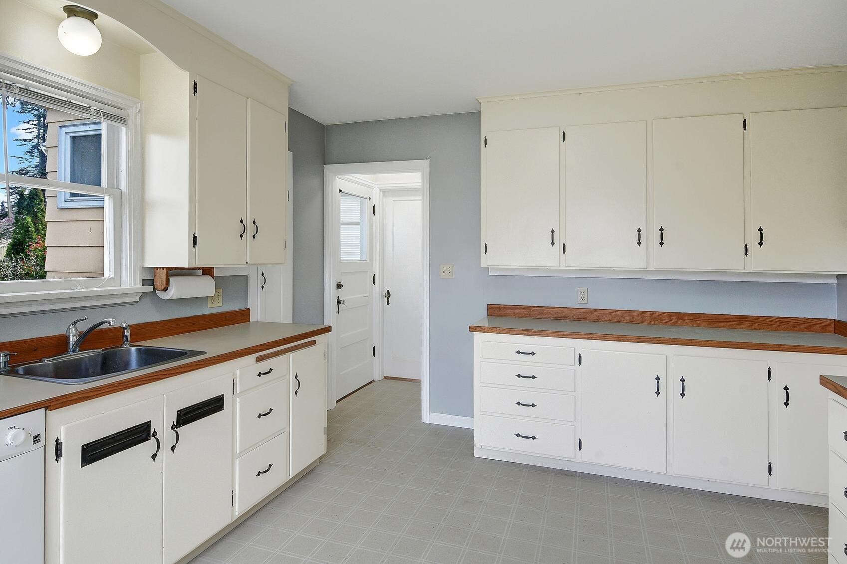 19330 20th Avenue Northwest Shoreline, WA 98177 - Photo 4 of 18 a spacious bathroom with white cabinets