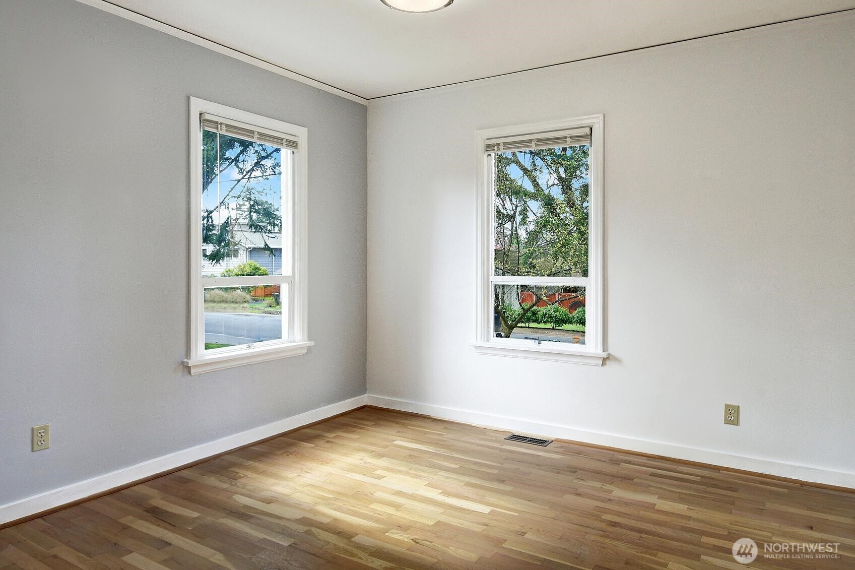 19330 20th Avenue Northwest Shoreline, WA 98177 - Photo 9 of 18 a view of an empty room with wooden floor and a window