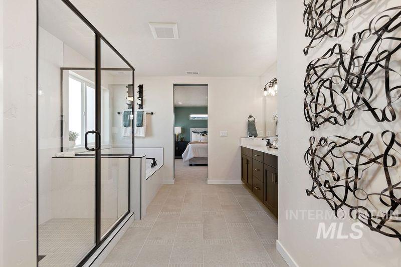 222 Omphale Street West Kuna, ID 83634 - Photo 8 of 11 Ensuite bathroom with vanity, a stall shower, and a bath