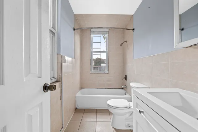 a bathroom with a toilet a sink and bathtub