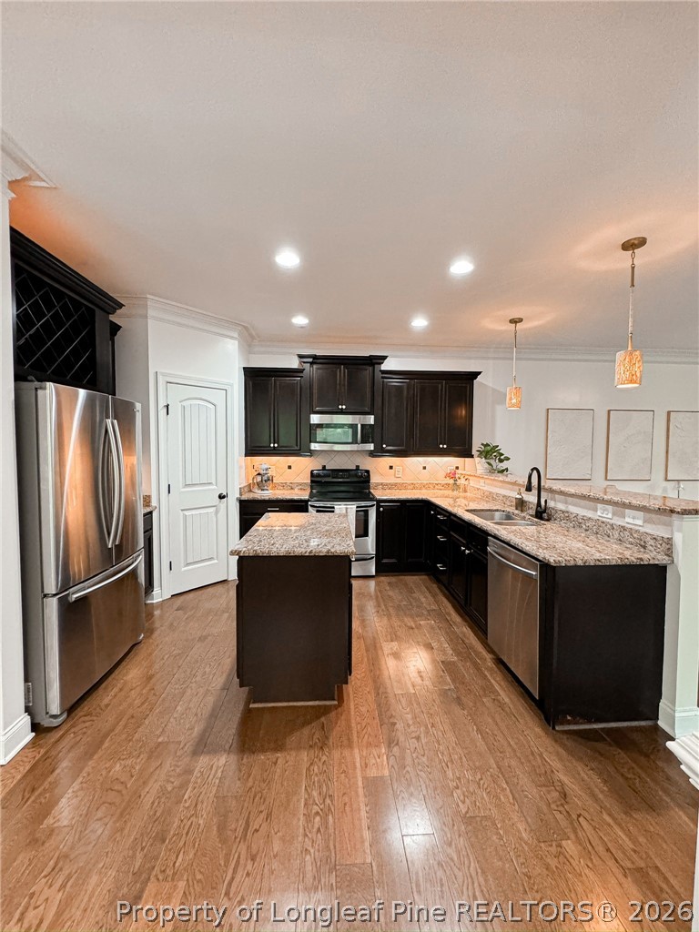 93 Falcon Ridge Drive Spring Lake, NC 28390 - Photo 16 of 50 a kitchen with stainless steel appliances kitchen island granite countertop a refrigerator a stove a sink dishwasher and a oven with wooden floor