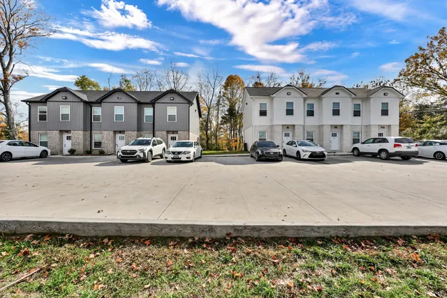 a front view of a building with a garden
