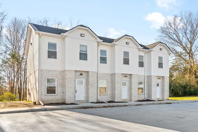 wooden floor in an empty room with a kitchen
