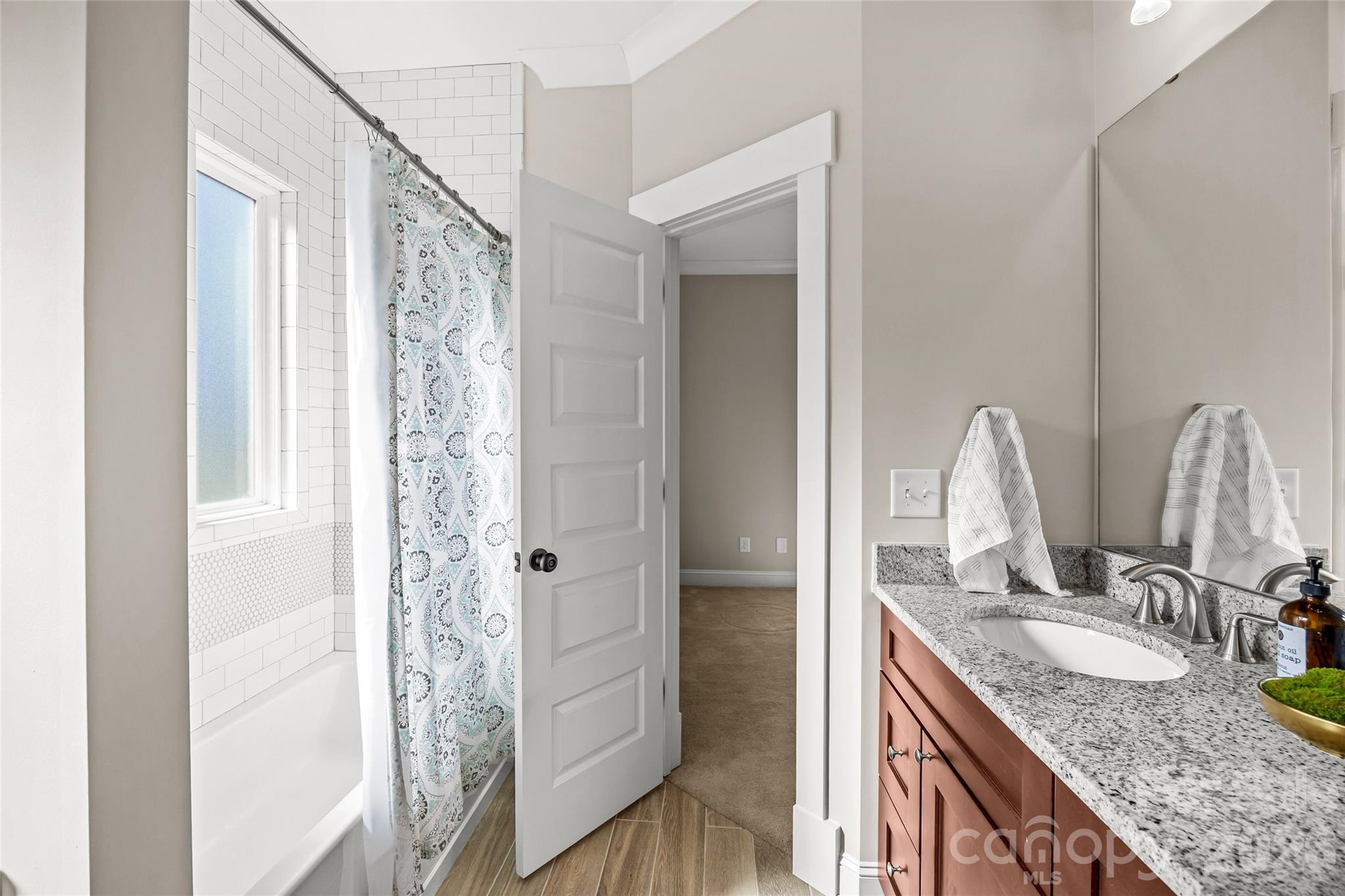 1728 Burgin Street Charlotte, NC 28205 - Photo 31 of 43 a bathroom with a granite countertop sink and a mirror