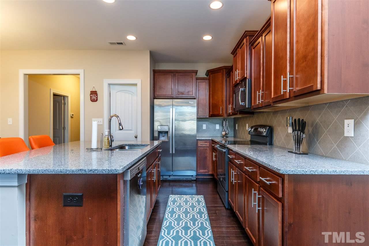 141 Token House Road Durham, NC 27703 - Photo 5 of 22 Fantastic Kitchen with beautiful granite counters and decorative backsplash. SS Appliances. Custom cabinetry and flowing hardwood flooring.