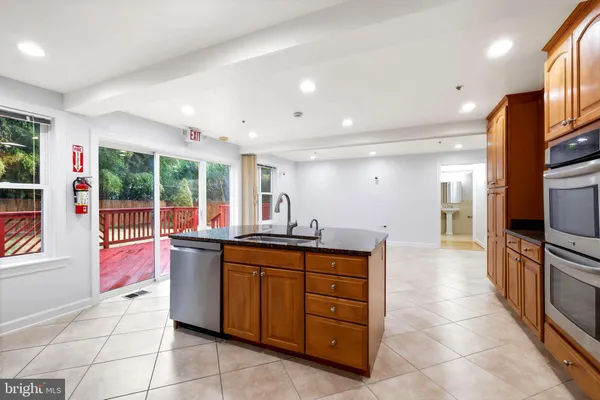 a kitchen with stainless steel appliances a sink and a refrigerator