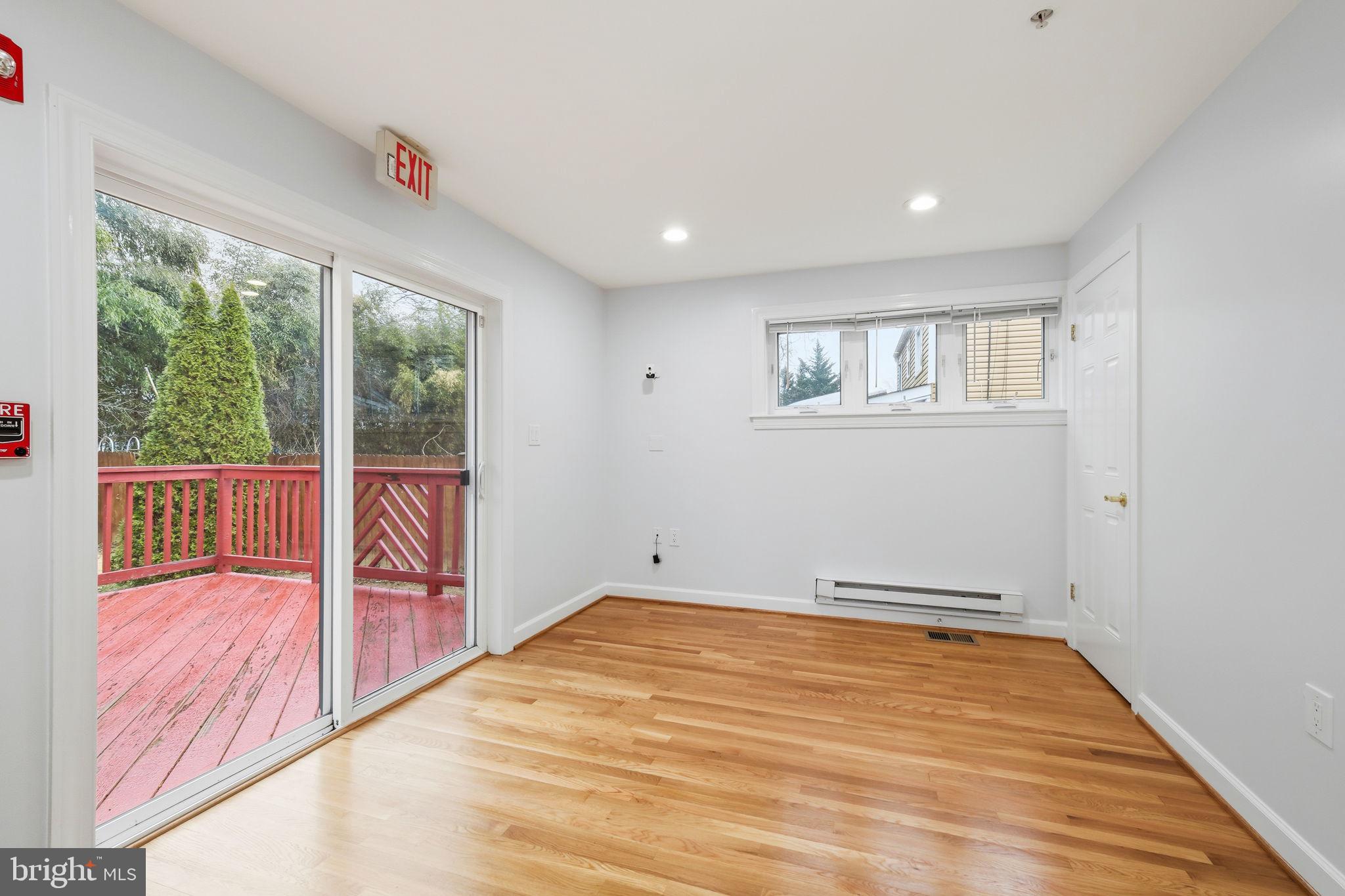 711 Lamberton Drive Silver Spring, MD 20902 - Photo 22 of 60 a view of an empty room with wooden floor and a window