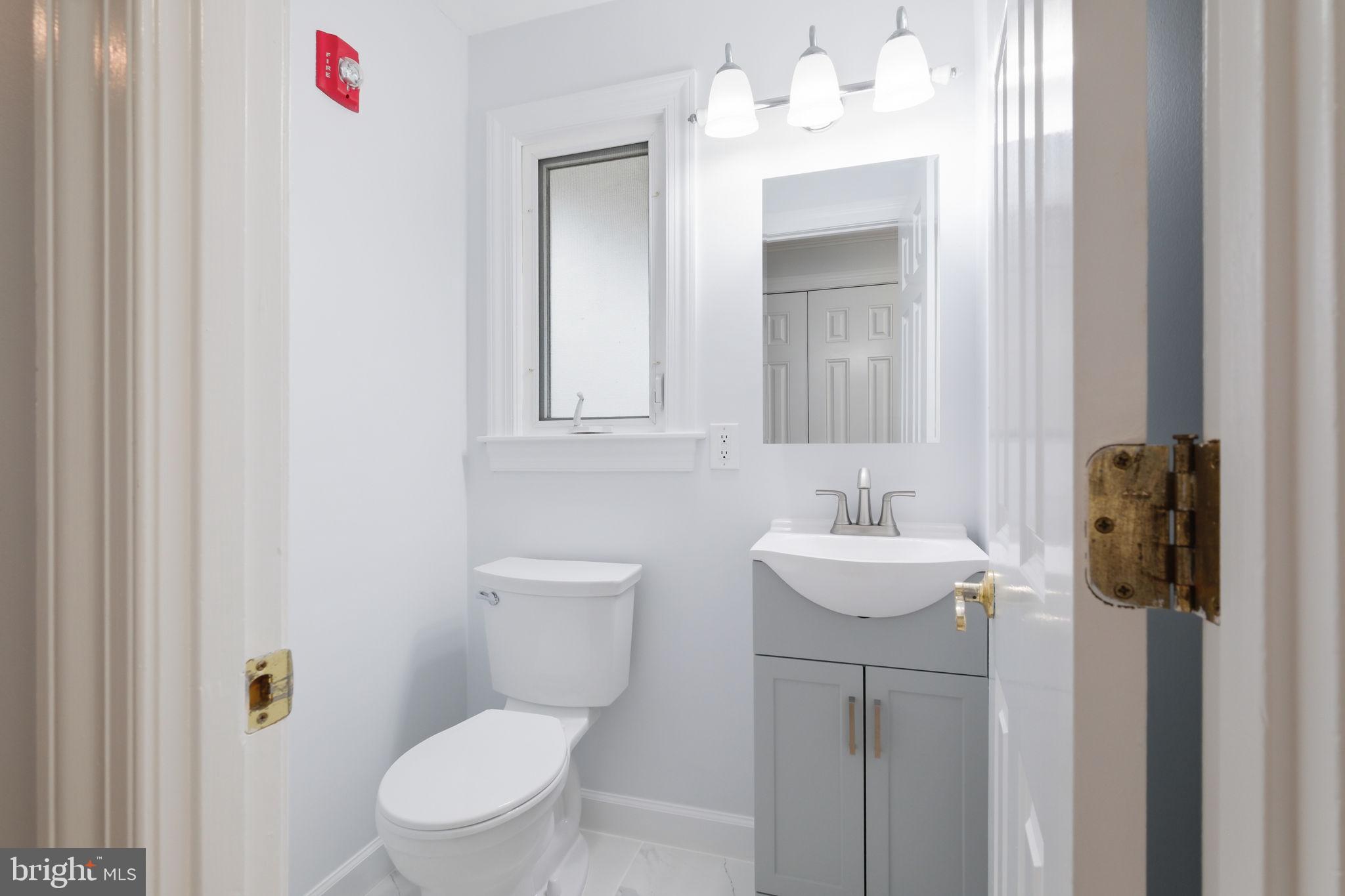 711 Lamberton Drive Silver Spring, MD 20902 - Photo 25 of 60 a bathroom with a toilet sink and mirror