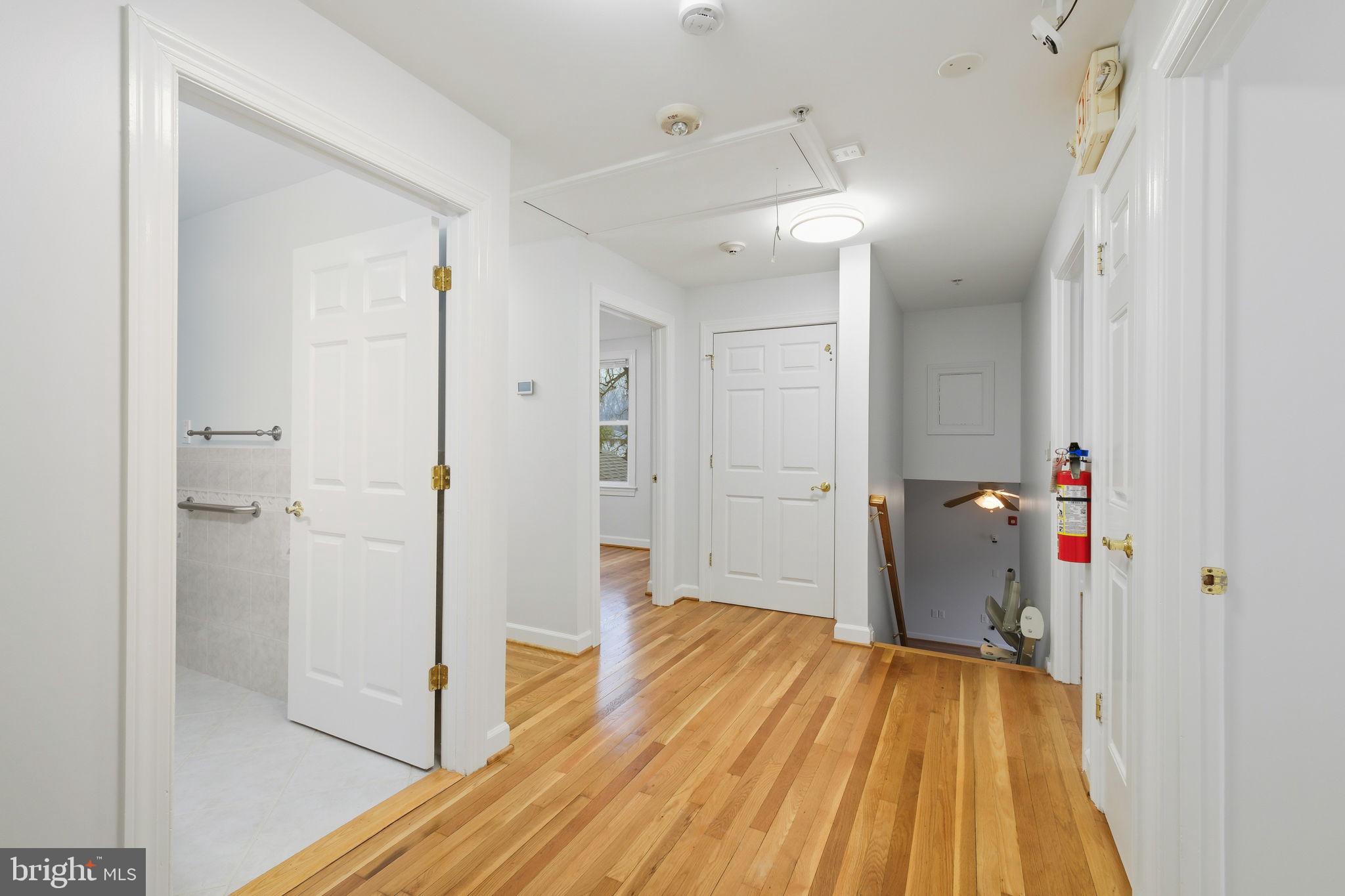 711 Lamberton Drive Silver Spring, MD 20902 - Photo 29 of 60 a view of a hallway with wooden floor and a bathroom