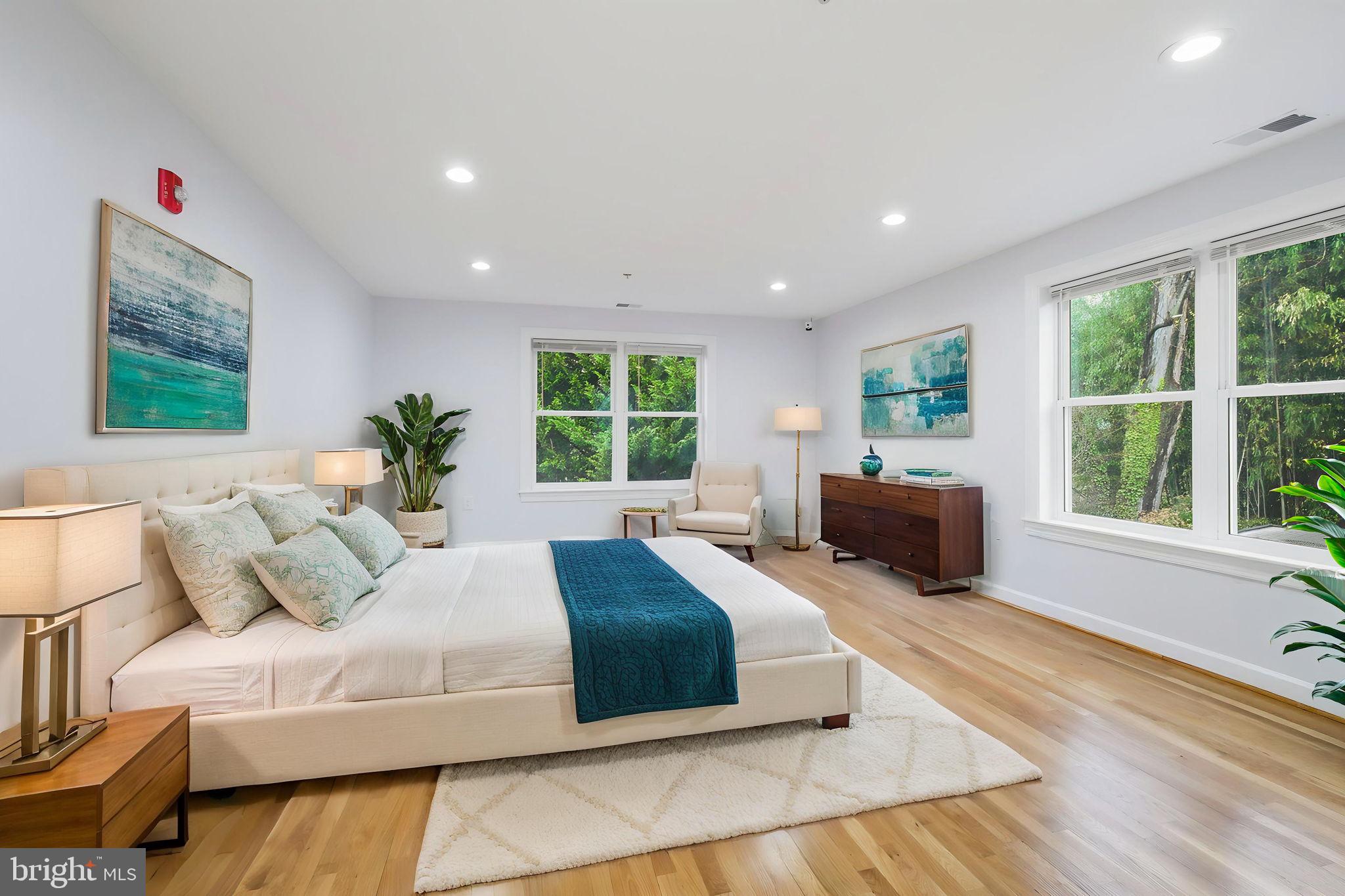 711 Lamberton Drive Silver Spring, MD 20902 - Photo 32 of 60 a spacious bedroom with a large bed and a large window