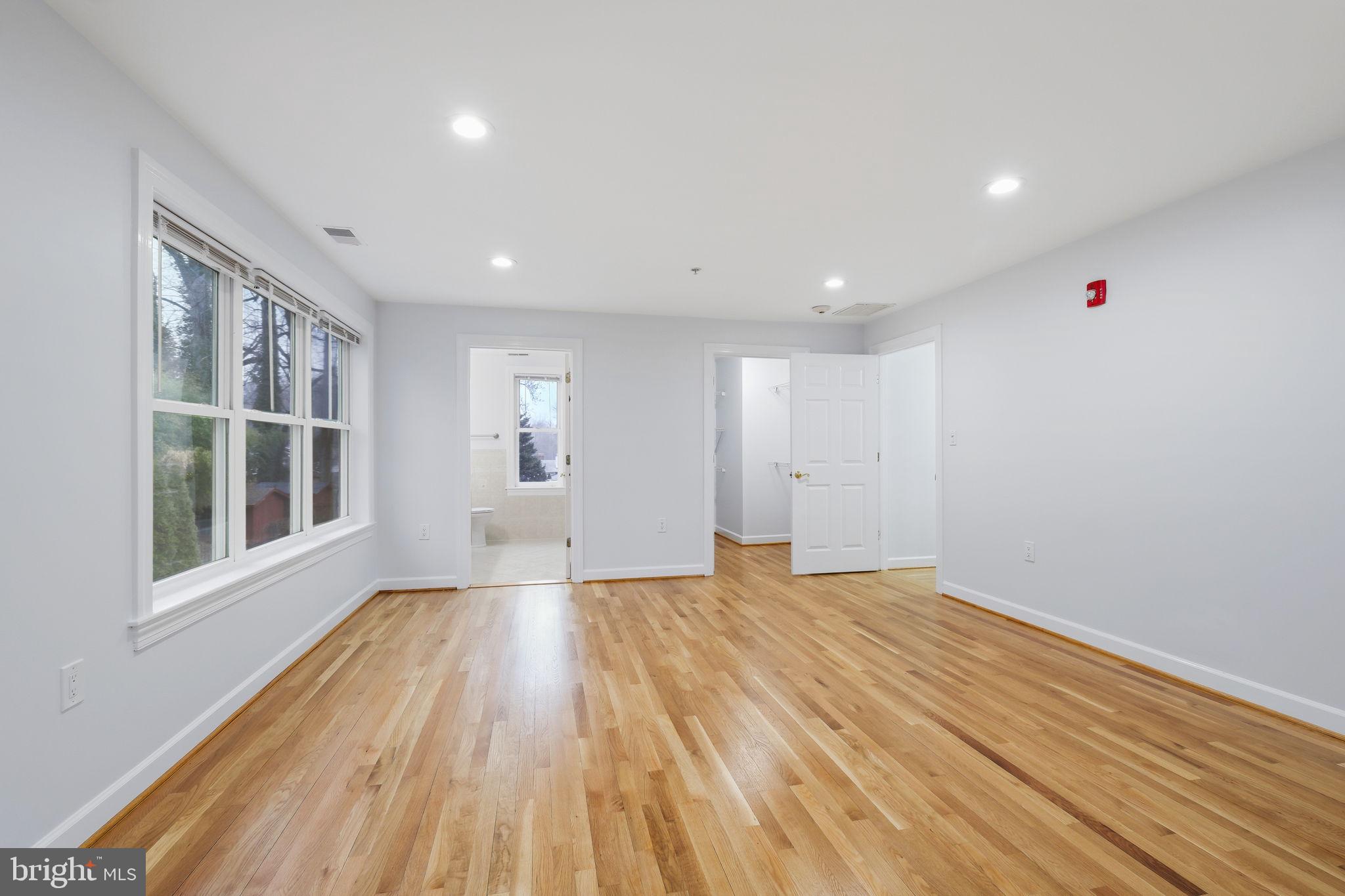 711 Lamberton Drive Silver Spring, MD 20902 - Photo 33 of 60 a view of an empty room with wooden floor and a window
