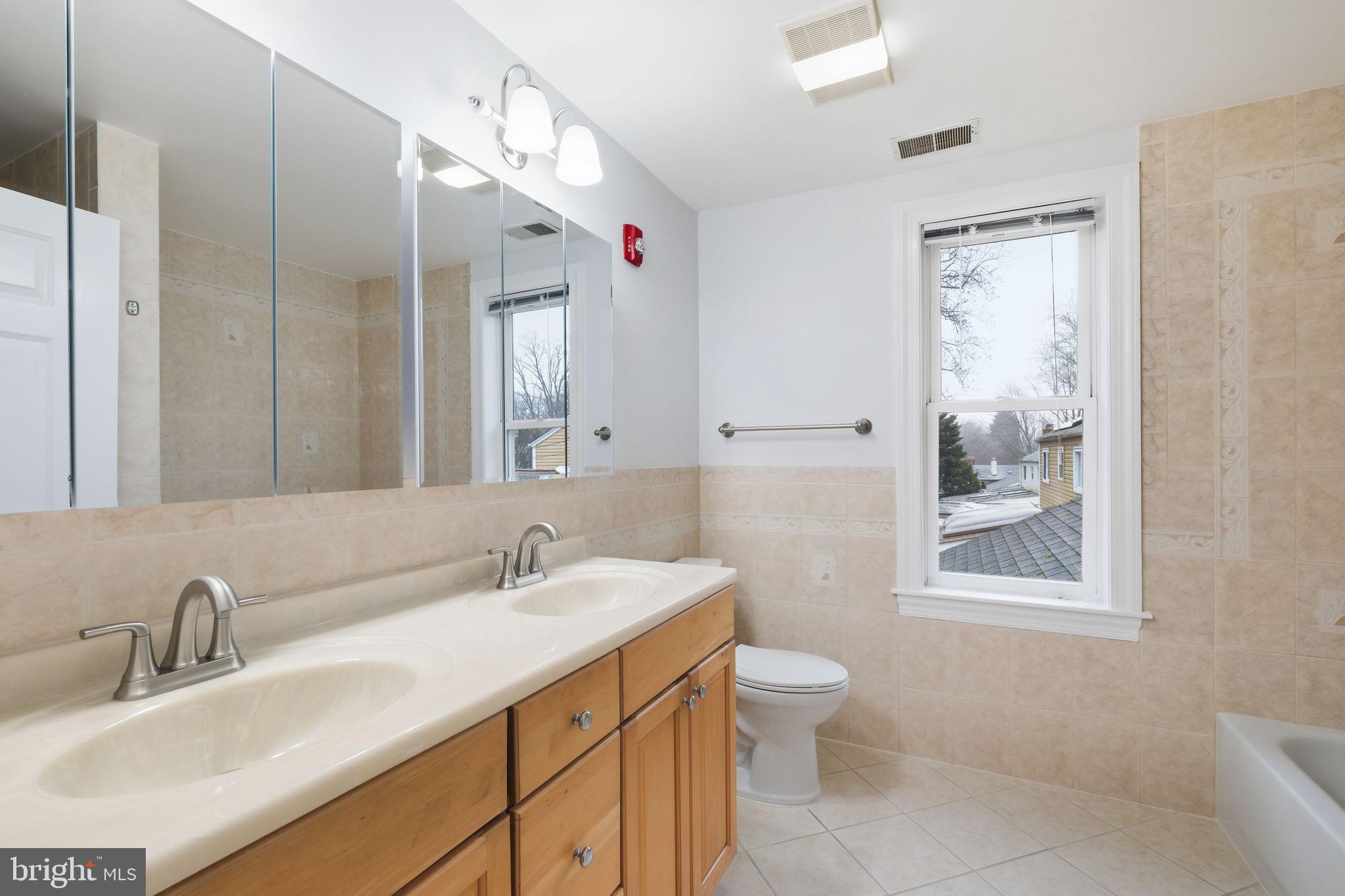 711 Lamberton Drive Silver Spring, MD 20902 - Photo 34 of 60 a bathroom with a sink vanity granite and toilet
