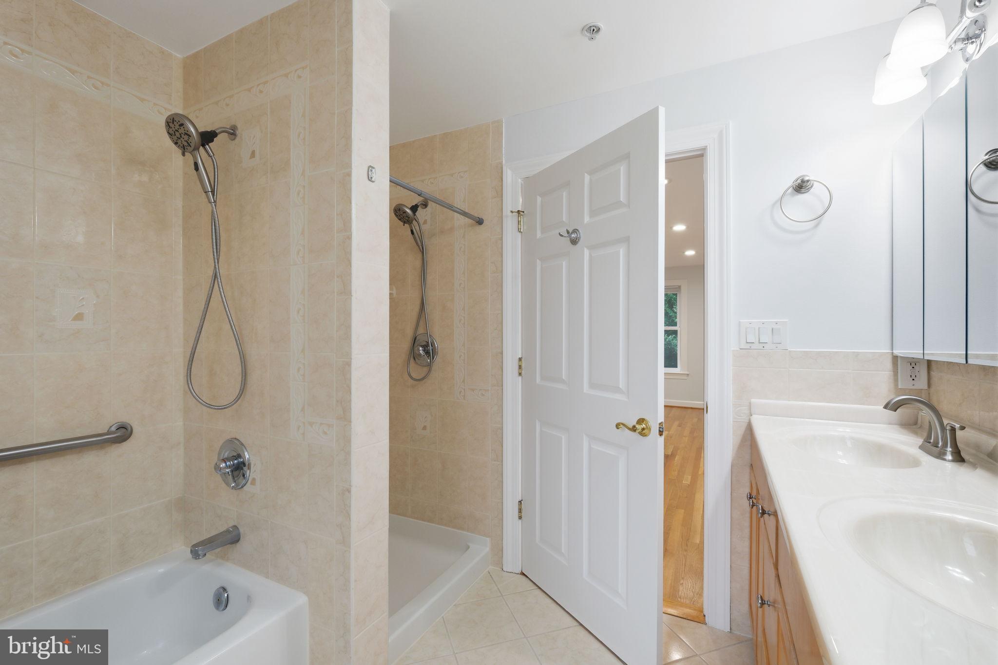 711 Lamberton Drive Silver Spring, MD 20902 - Photo 35 of 60 a bathroom with a bath tub sink mirror and shower