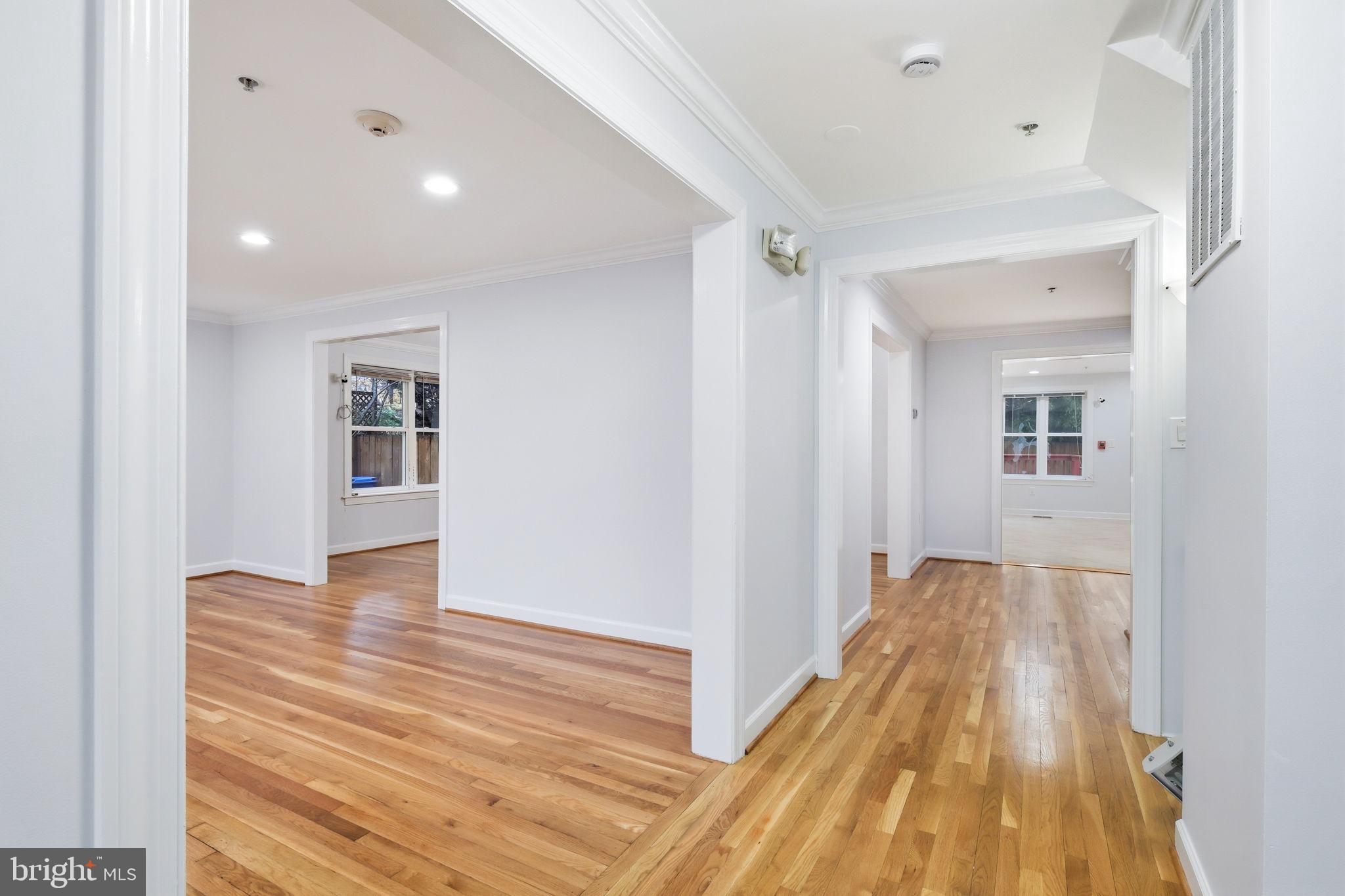 711 Lamberton Drive Silver Spring, MD 20902 - Photo 4 of 60 a view of a hallway with wooden floor and a living room