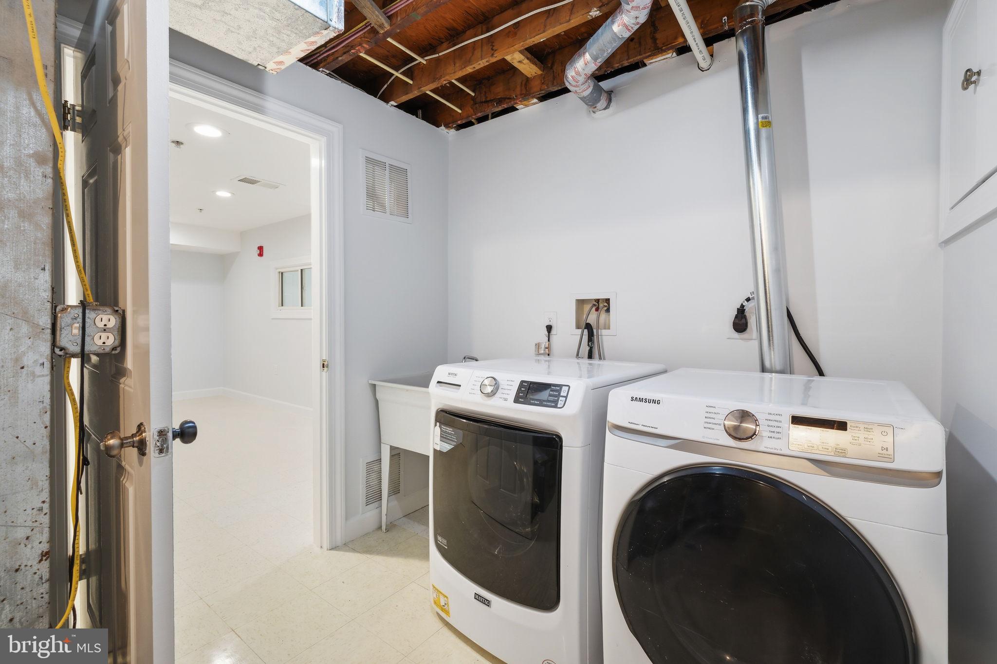 711 Lamberton Drive Silver Spring, MD 20902 - Photo 50 of 60 a view of washer and dryer with bathroom in the background
