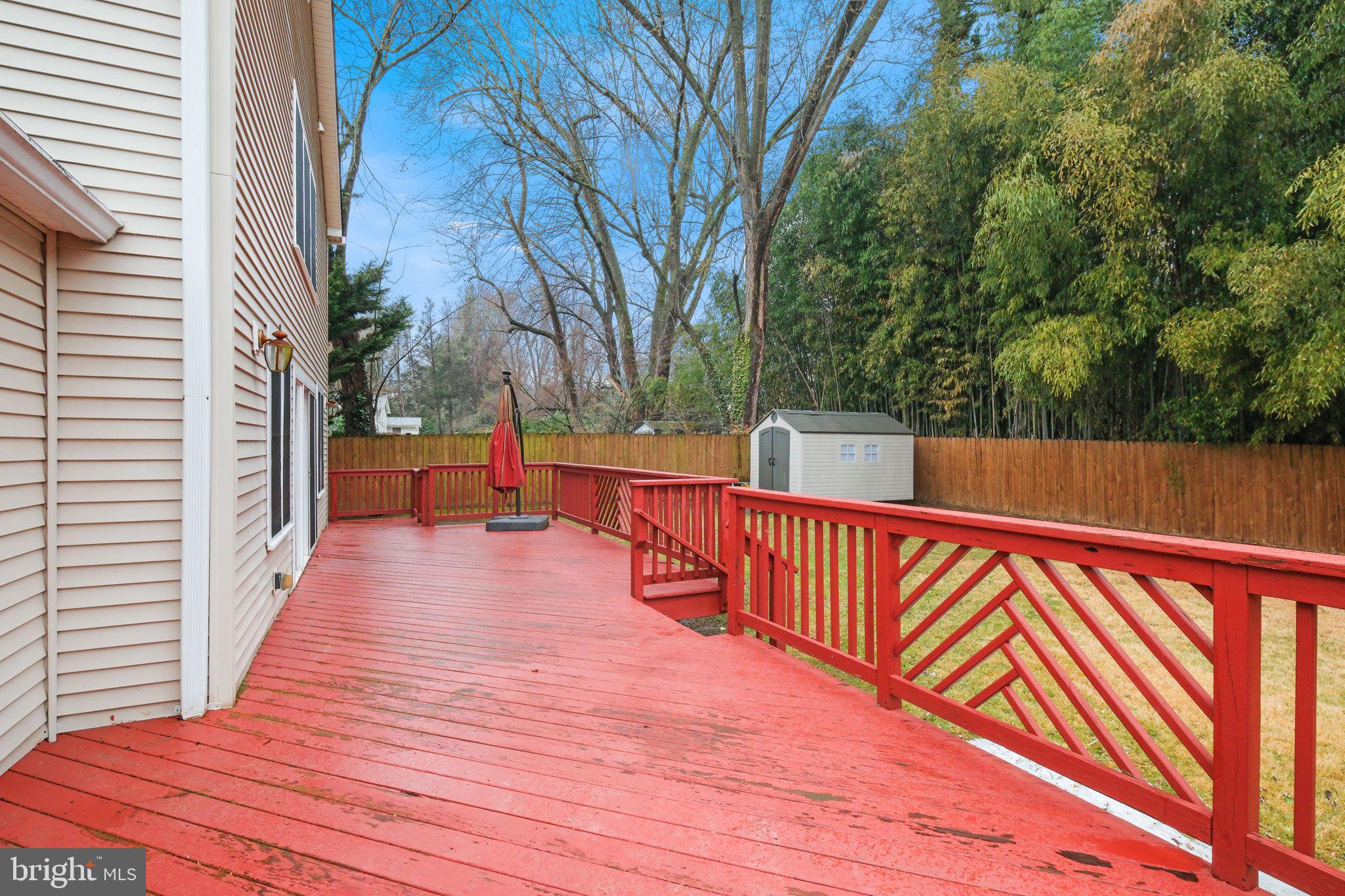 711 Lamberton Drive Silver Spring, MD 20902 - Photo 52 of 60 a balcony with wooden floor and trees in the back