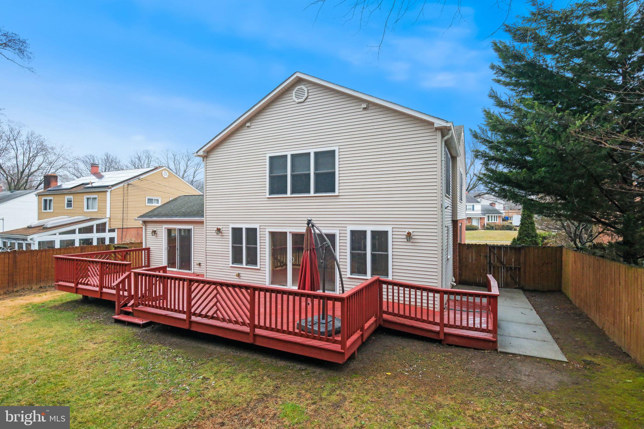 711 Lamberton Drive Silver Spring, MD 20902 - Photo 54 of 60 a view of a house with a wooden deck and a yard