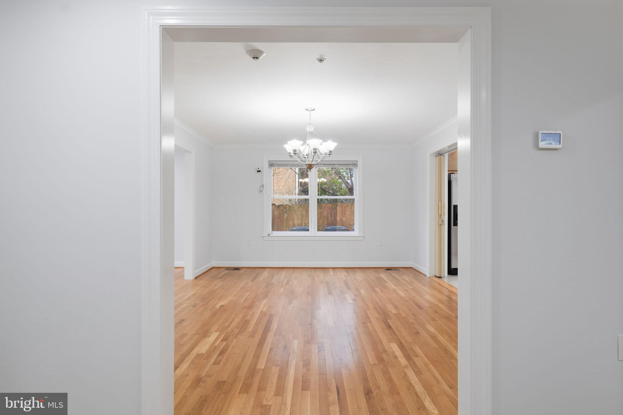 711 Lamberton Drive Silver Spring, MD 20902 - Photo 10 of 60 a view of an empty room with a window and wooden floor