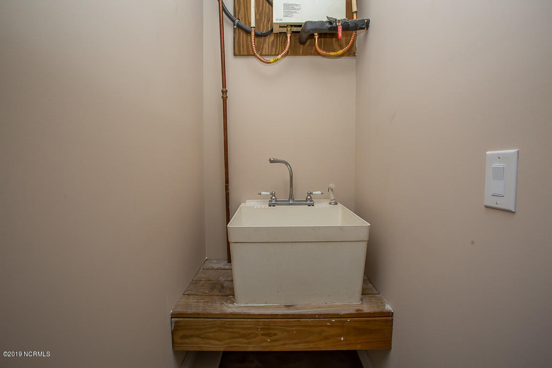 69 Persimmon Road Southwest Carolina Shores, NC 28467 - Photo 33 of 40 UTILITY SINK IN GARAGE