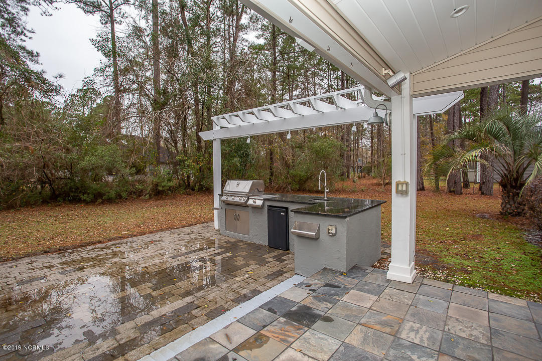 69 Persimmon Road Southwest Carolina Shores, NC 28467 - Photo 35 of 40 OUTDOOR KITCHEN/GRANITE COUNTERTOP/STAINLESS GRILL & SINK