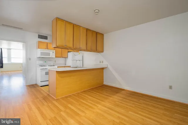 a kitchen with stainless steel appliances wooden cabinets and a sink