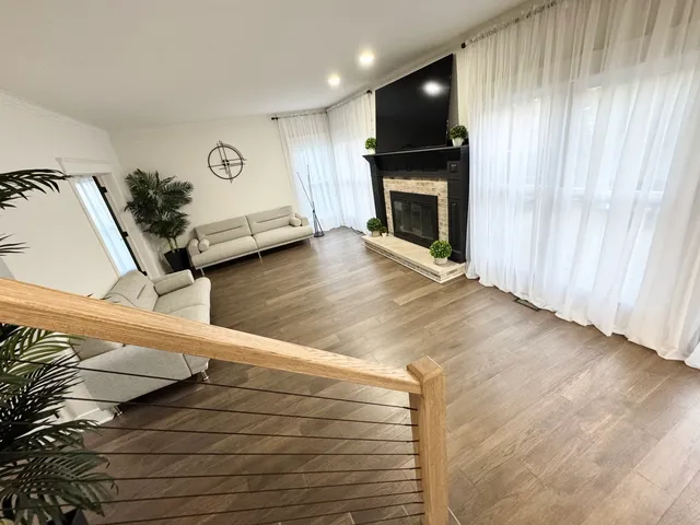 a view of entryway and hall with wooden floor