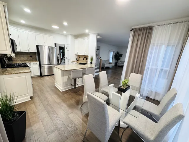 a view of a dining room with furniture and a window