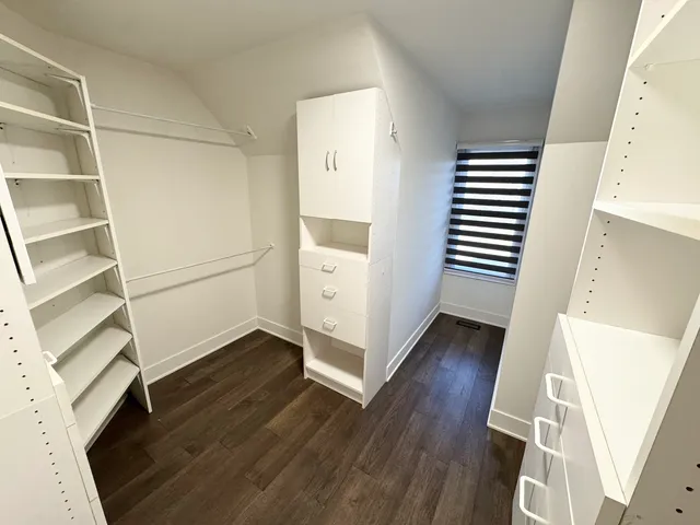 a view of a room with wooden floor and white walls