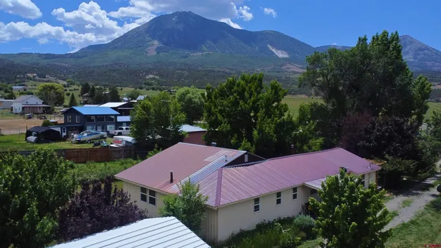 a view of a patio with furniture and a yard
